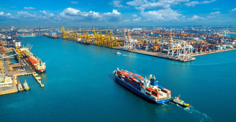 aerial view of cargo ship and cargo container in harbor.