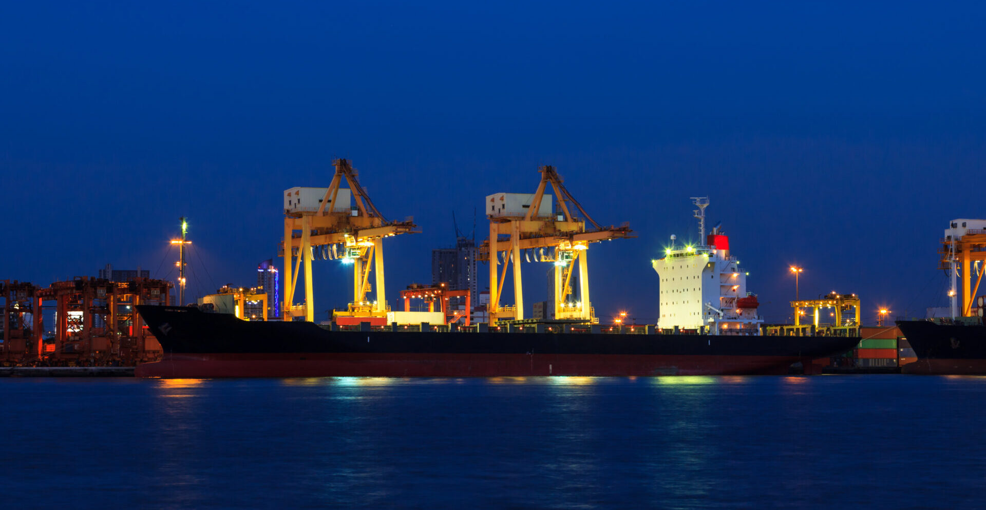 container cargo freight ship at port twilight