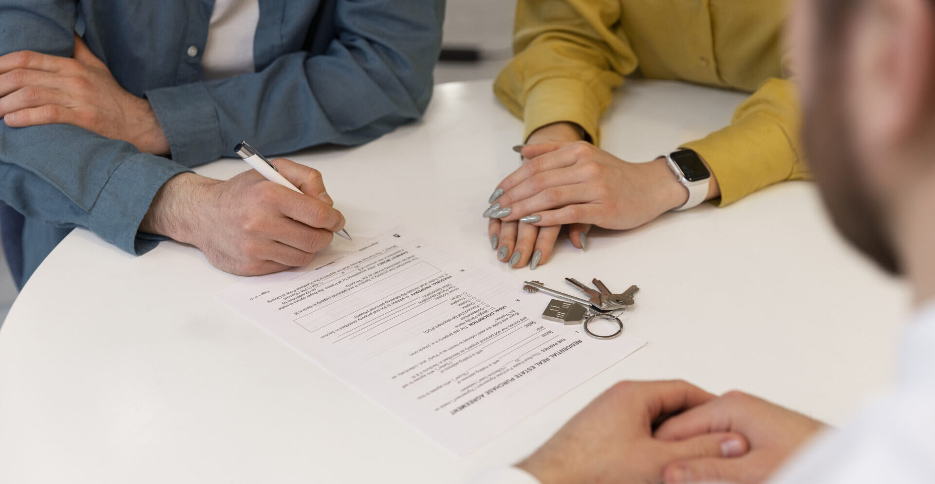 male real estate agent doing business showing house potential buying couple